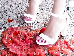 Tomato crushed and destroyed under White heels