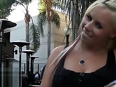 Sexy blonde out in public showing off her pussy with people all around