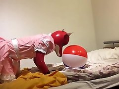 Rubber fox maid plays with beach ball