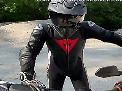 biker is pissing in his leather suit
