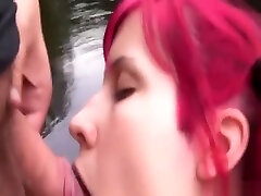 Redhead girl blows young sot outdoors