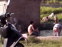 Chinese Men swimming at lake