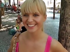 Sexy girl shows tits in the middle of a lively square