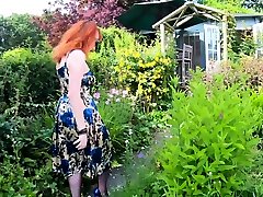 Busty babe Red XXX fingers herself in the garden