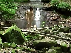 Naked sissy sashaying hiking in a scenic canyon