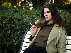 Young Brunette Is Taking An Unhurried Stroll With Allwhite 120mm Cigarette