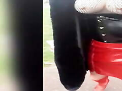 Sissy, outdoor exhibition in red cum for castration black outfit