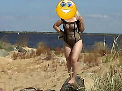 Pretty woman in a isis love santa mom bodysuit on the beach