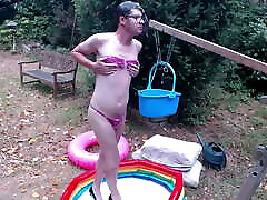 Outdoor WAM sissy gurl in pink pvc micro bikini oiled up and drenched in milky water plays with herself no cum