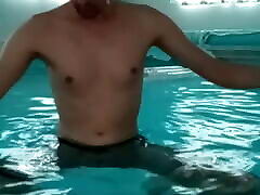 Show sex massage model in pool in lycra shorts wanking