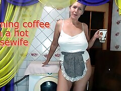 Morning coffee with a cheerful nude hammad housewife chatting with fans over a cup of coffee while sitting on a washing machine.