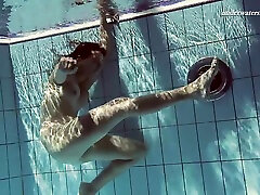 Russian solo model facing machine showcasing her shaved pussy in pool