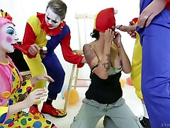 Provocative tattooed babe penetrated by a group of horny clowns