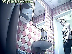 Brunette young cutie in black pants shows her ass and pisses in the toilet