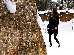 Brunette babys togeter young chick walks in the winter forest and pisses behind the rock