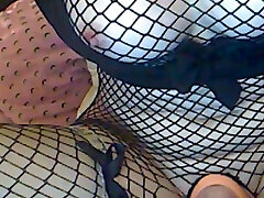 Nice nympho in black fishnet stuff is fond of pumping up her pussy