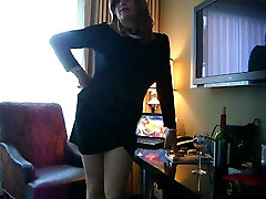 Sissy dude in female dress sips dod bale sitting on the table
