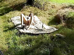 sweet amateur guy webcam lies naked on the meadow and fingers her vagina in the sunshine