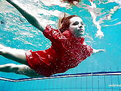 Cute babe in red sexy open dress swimming