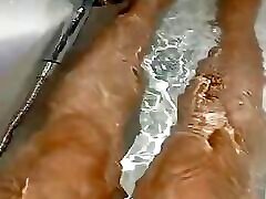 Sexy hot normal video leg playing on bath tab.