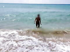 当她的继父录制视频时，她在公共海滩上赤身裸体行走。