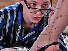 Sexy lady rubs her nyloned feet against the face of a nerdy guy as foreplay