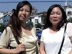 Two lustful Japanese girls give a hand-job to a guy