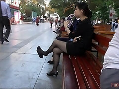 Chinese Office Woman having a break and dangling her heels