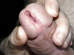 She kneads the penis thru the panties and opens the urethra.