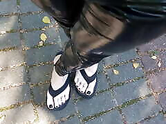 high platform flip flops and latex leggings in public