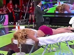Athletic lady receives a massage live on the slepp ass