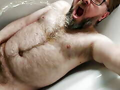 Some solo chastity watersports in the bath for this piss thirsty locked bear